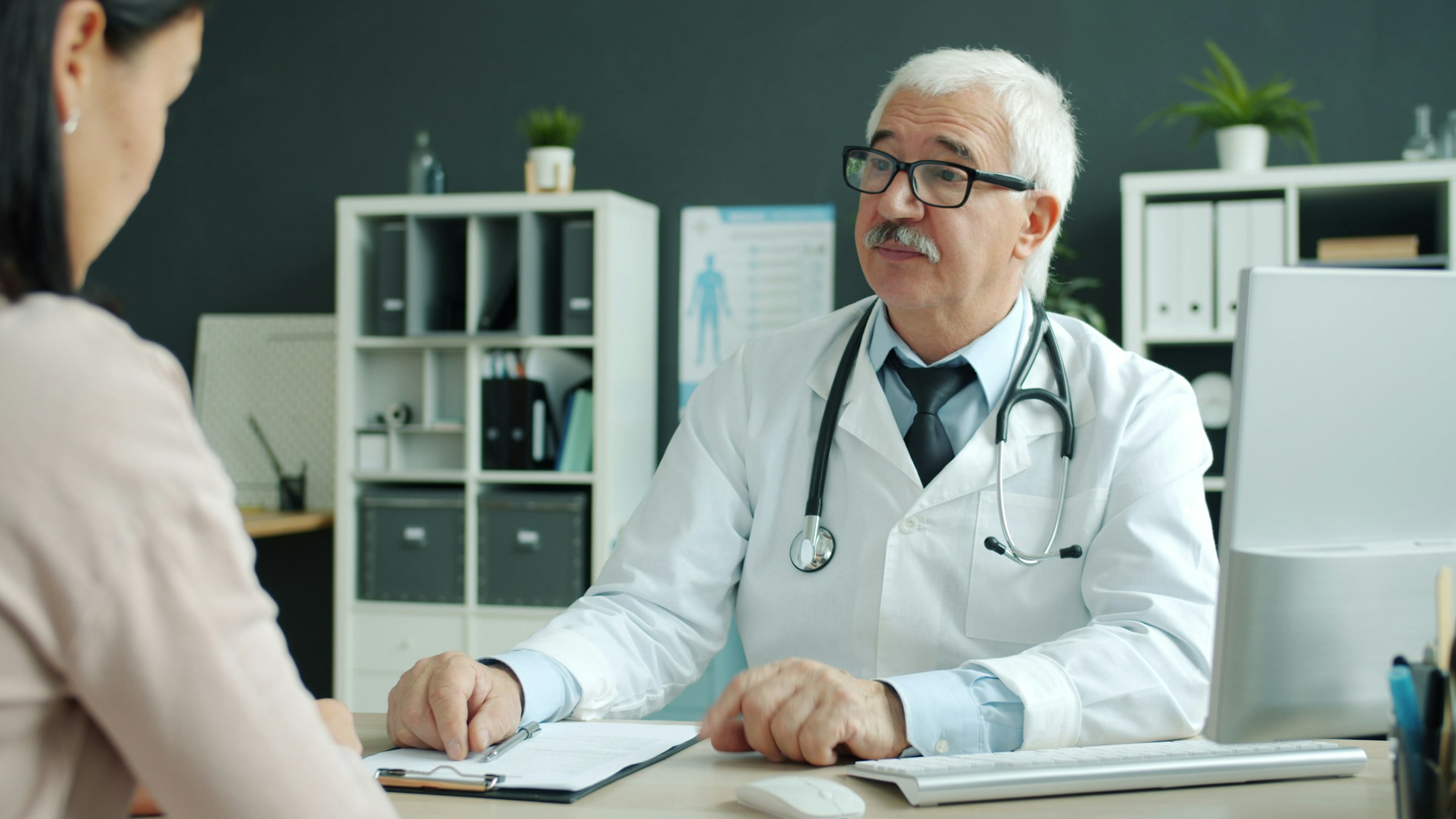 A clinician reviewing study information with a patient.